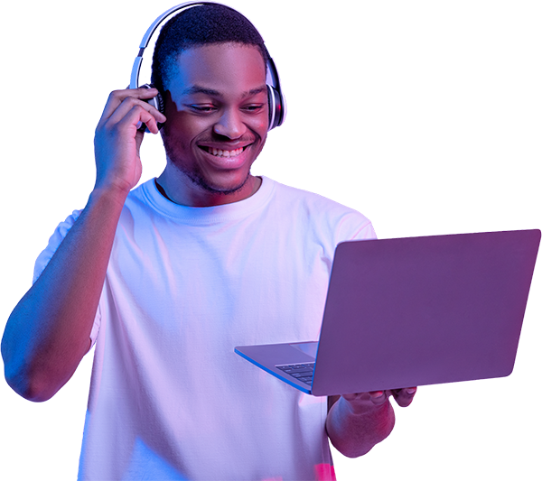 Young man with headphones smiling and holding laptop